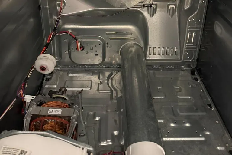 Dryer cabinet opened to show the heater and airflow path